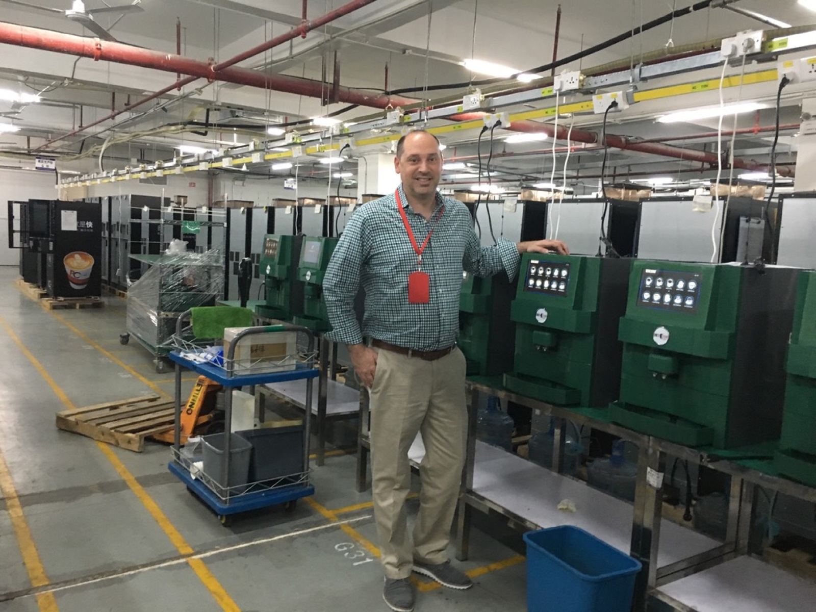 Travis Estes on the factory production floor where Busy Bean machines are built
